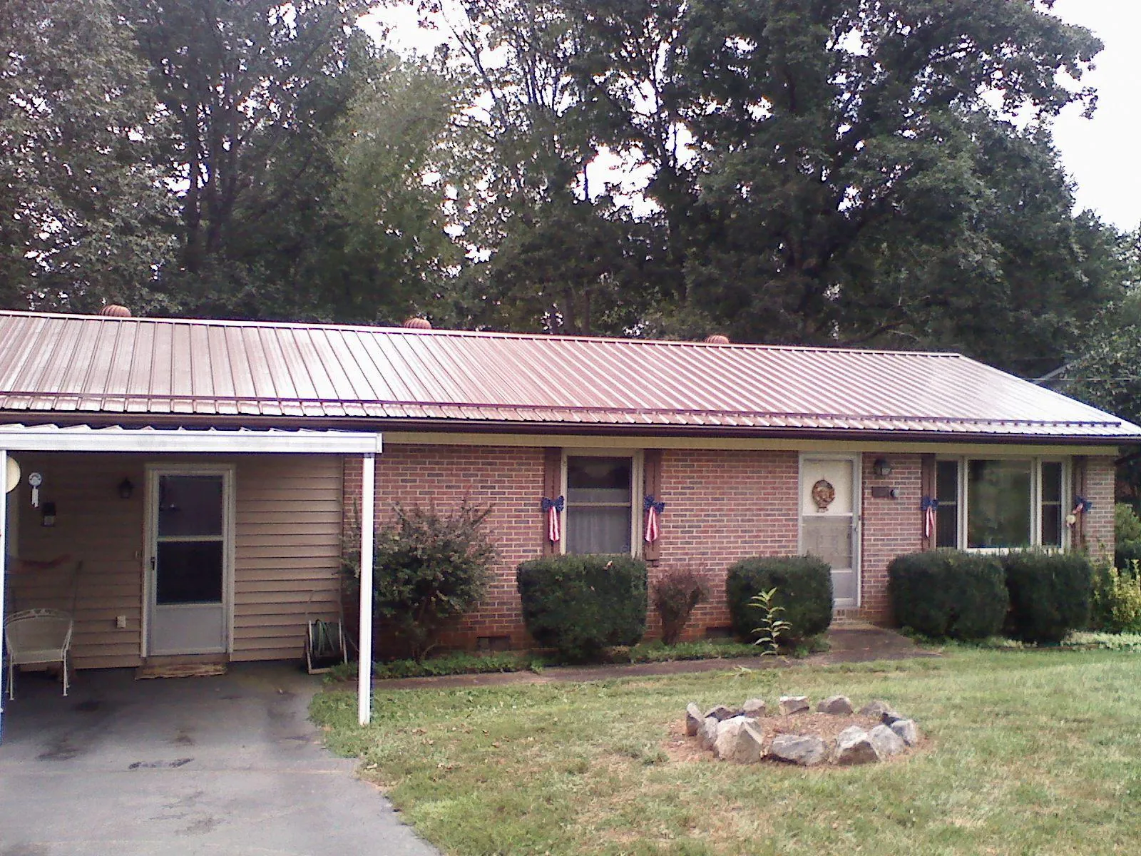 Bronze metal roof and carport on a brick ranch home — Roof Repair work by our crew in Riverview